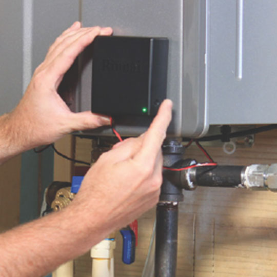 Hands installing electrical component of a water heater