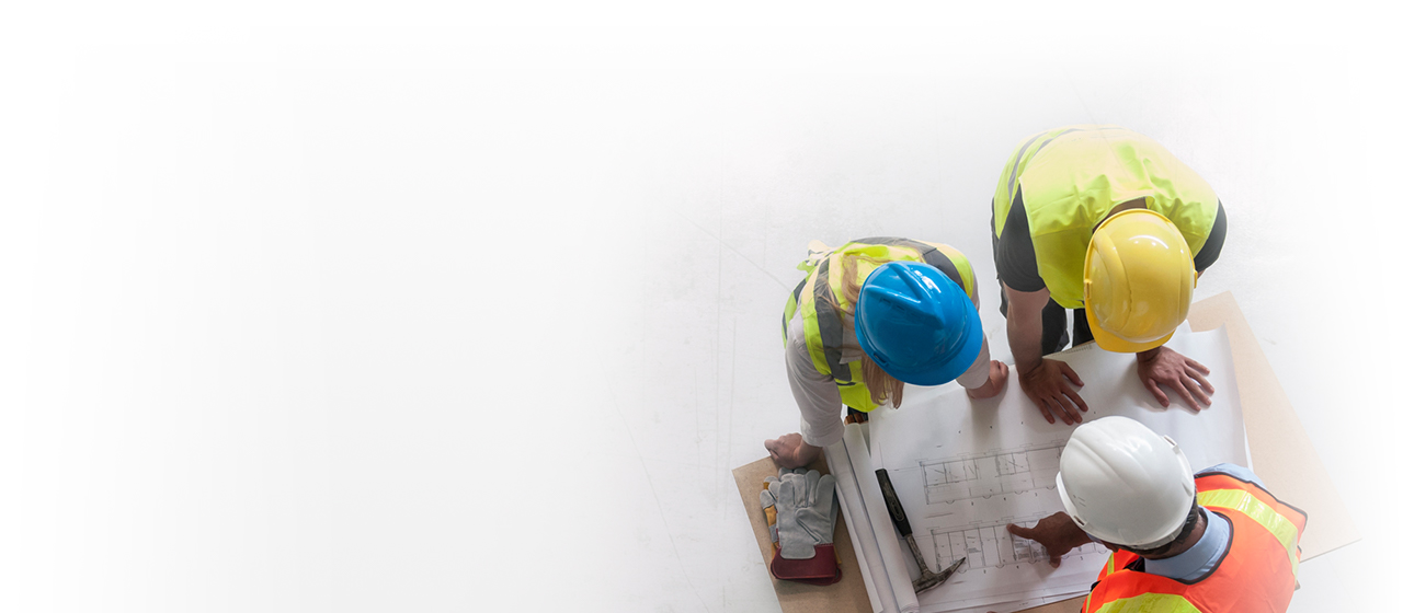 Workers analyzing building plans.