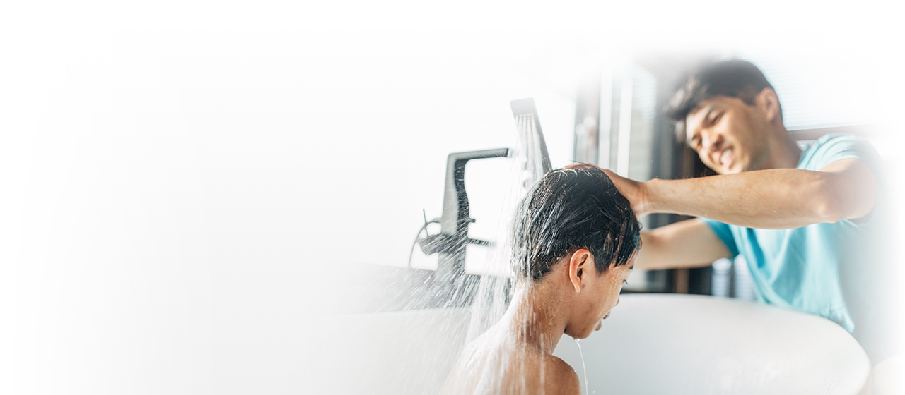 Man bathing toddler